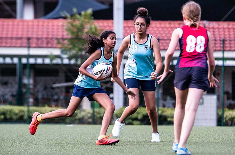 Girls playing Touch Rugby friendly game